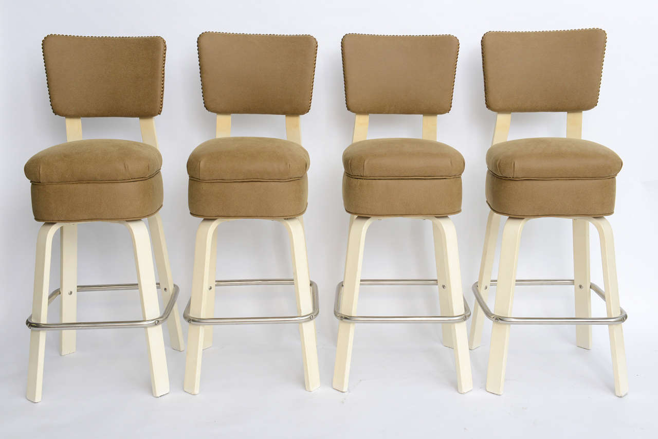 SOLD  Beefy, beautiful and bold.  These four swiveling Thonet 1940s barstools by Joe Atkinson have been reupholstered in a very soft shagreen embossed vinyl with dark brass nail-head trim.  Re-chromed brushed finish on the foot bars and having their