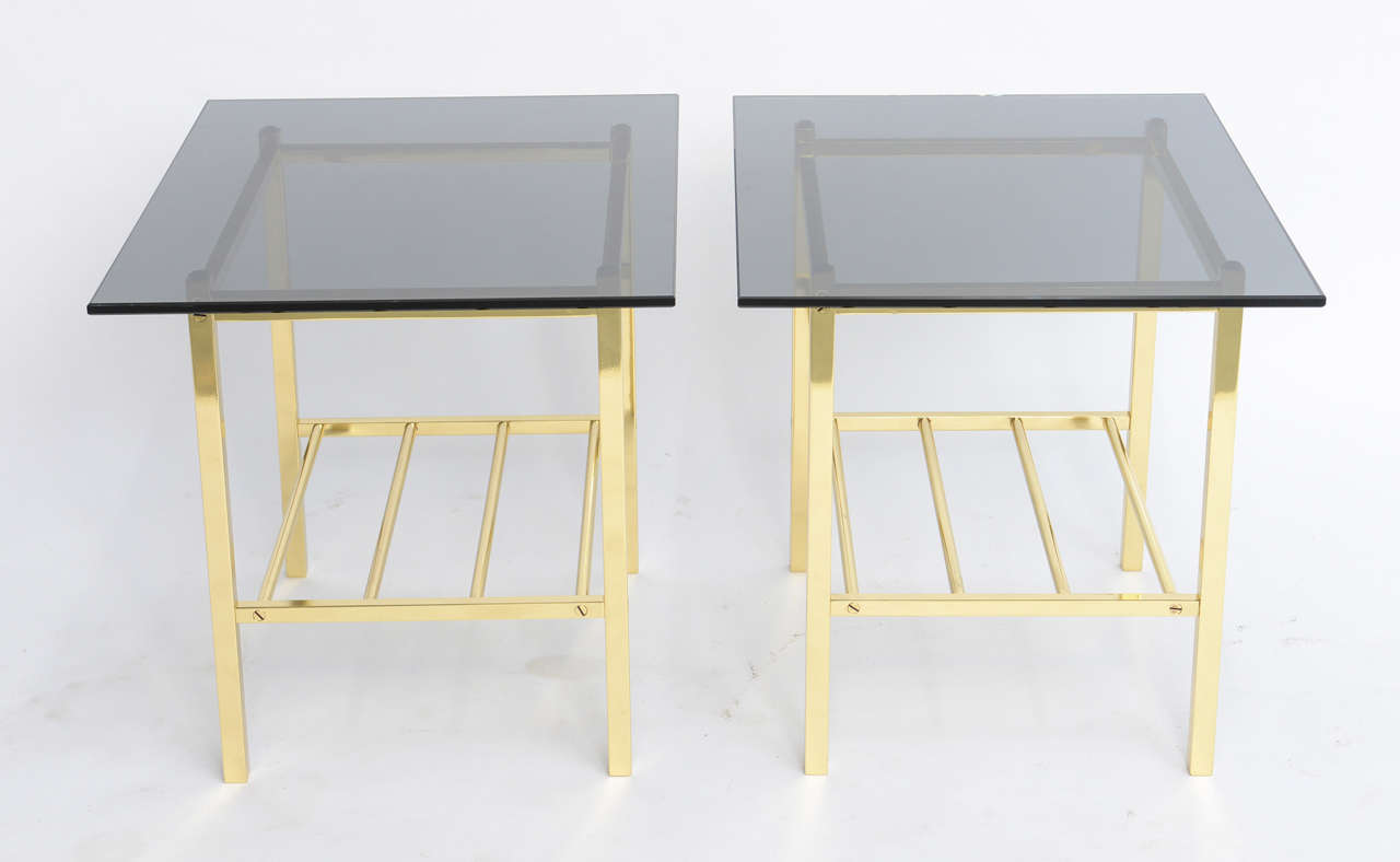 Wonderful pair of Minimalist polished solid brass side tables with dark smoked glass tops. Tubular brass stretcher shelf. Superior craftsmanship. Cocktail tables, end tables, nightstand or bedside tables.
Price is for the pair.
Measurements:
Glass