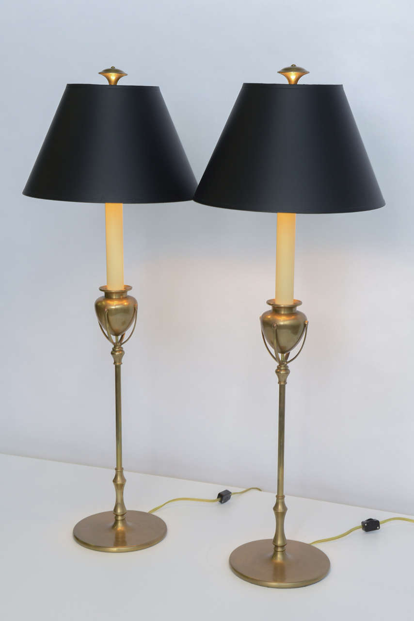Styled after Tiffany model 1213 Art Nouveau candlesticks, this pair of Chapman table lamps are magnificent. Deftly created, they feature a tall scale, solid brass design and retain their original black, gold foil shades. Medium base sockets, with