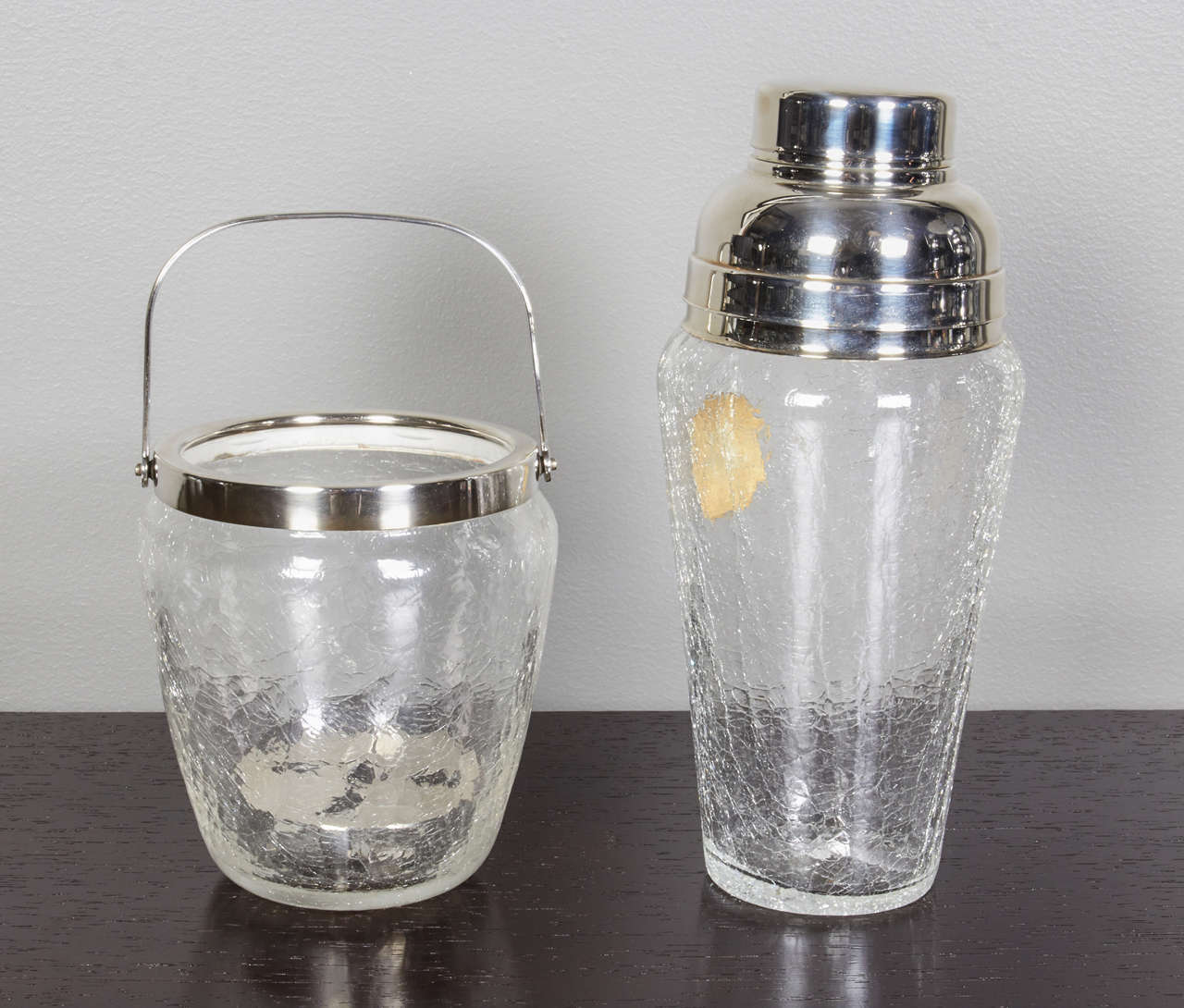 A great set of icy glass ice bucket and cocktail shaker. Silver-plated accents. Ice bucket has a drain insert. The cocktail shaker has the original label. Can be purchased individually.

Ice Bucket: 4.25