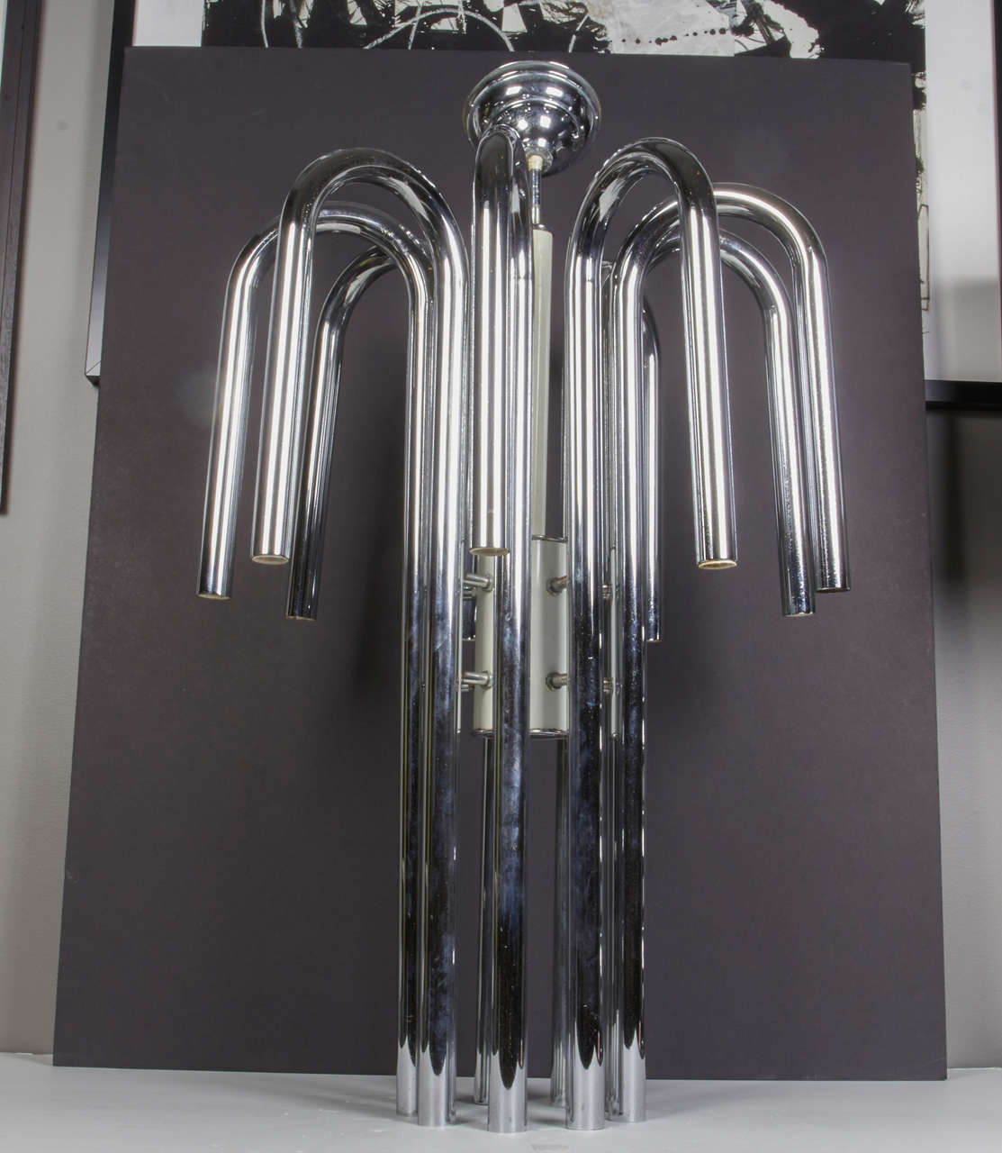 Impressive 1970s modernist waterfall chandelier. Elegant design as well as great light output. Nine sockets on top tubes and nine sockets on bottom tubes. It takes a total of eighteen 25 watt max chandelier bulbs. It is mostly chromed steel with
