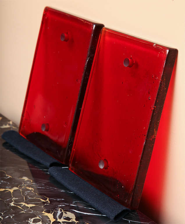 A pair of ruby red glass panels to be used alone as door plates or behind mounted handles.