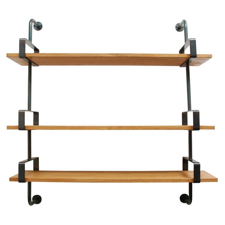 Incredible and sleek French designed bookshelf. Heavy aged iron wall brackets with rectangular slots for floating white oak planks of wood. Modern and industrial style with great functionality.

Multiples available with new production. Can have