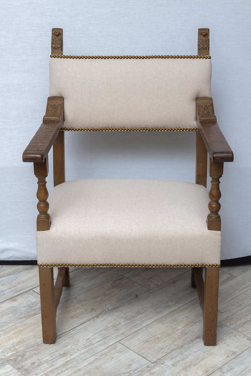 Handsome pair of armchairs with new upholstery and nail head trim.