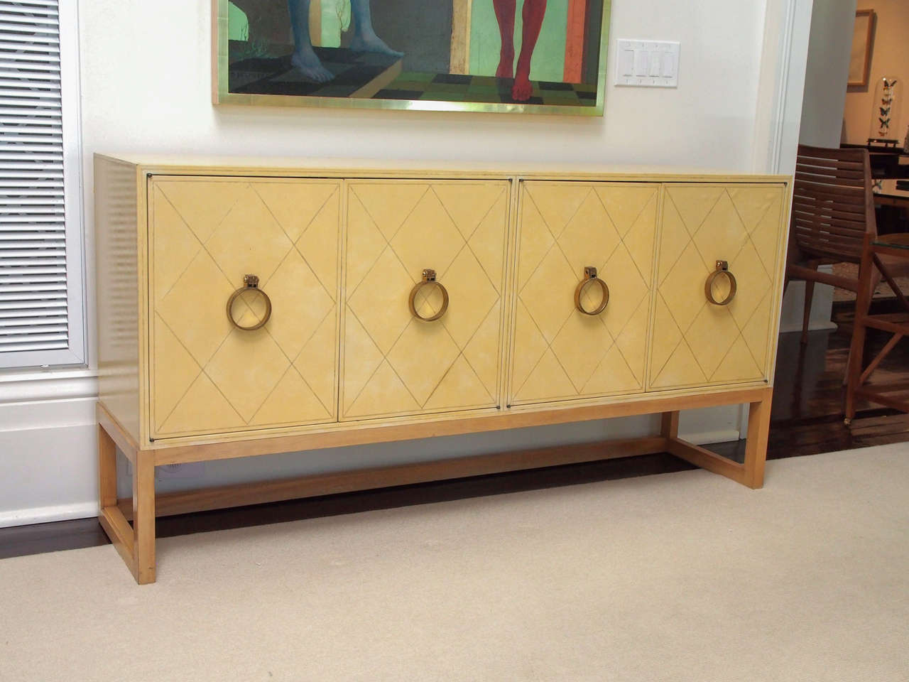 Credenza or sideboard by Tommi Parzinger (1903-1972) for Charak Modern, circa 1940s. Retaining its Charak Modern paper label. Each cabinet opening with two doors, one drawer and one adjustable shelf (shown resting at bottom of cabinets). The whole