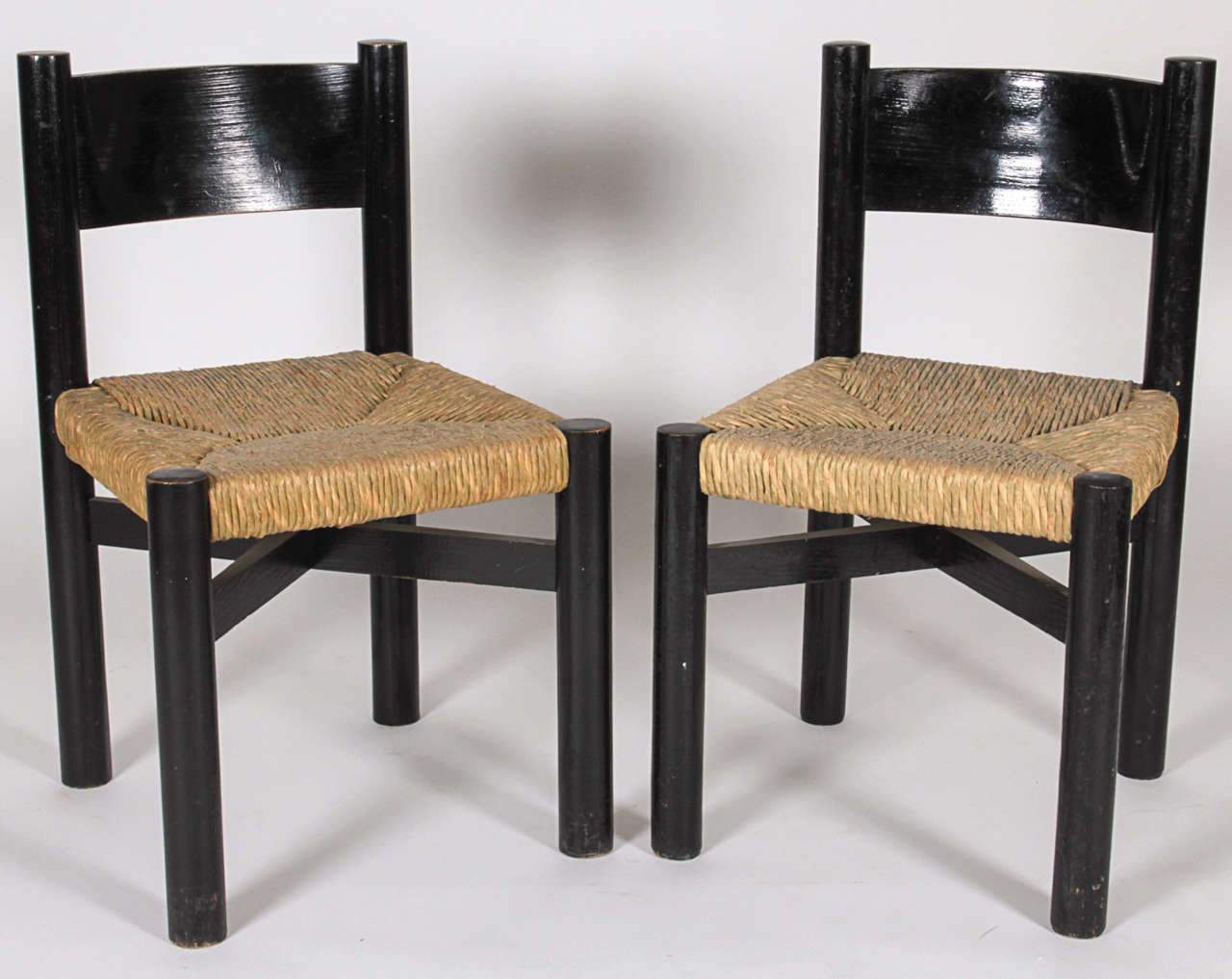 Charlotte Perriand, Circa 1960
Set of six chairs in black painted wood and rush.
