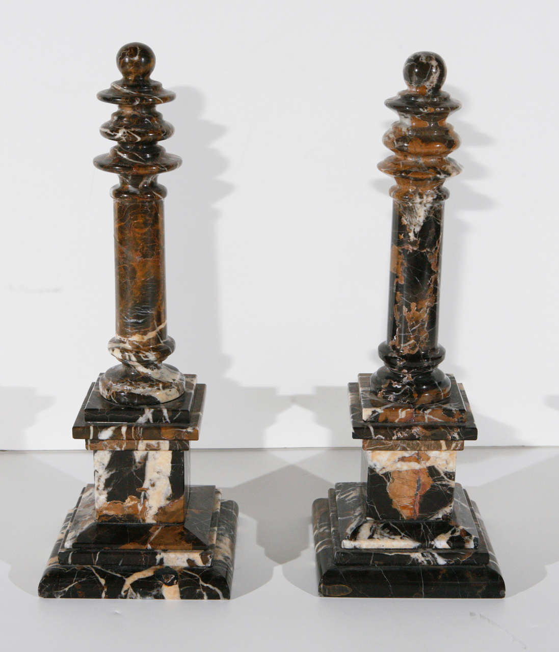 Pair of turn-of-the-century, hand-carved, chocolate marble obelisks with turned pinnacles.