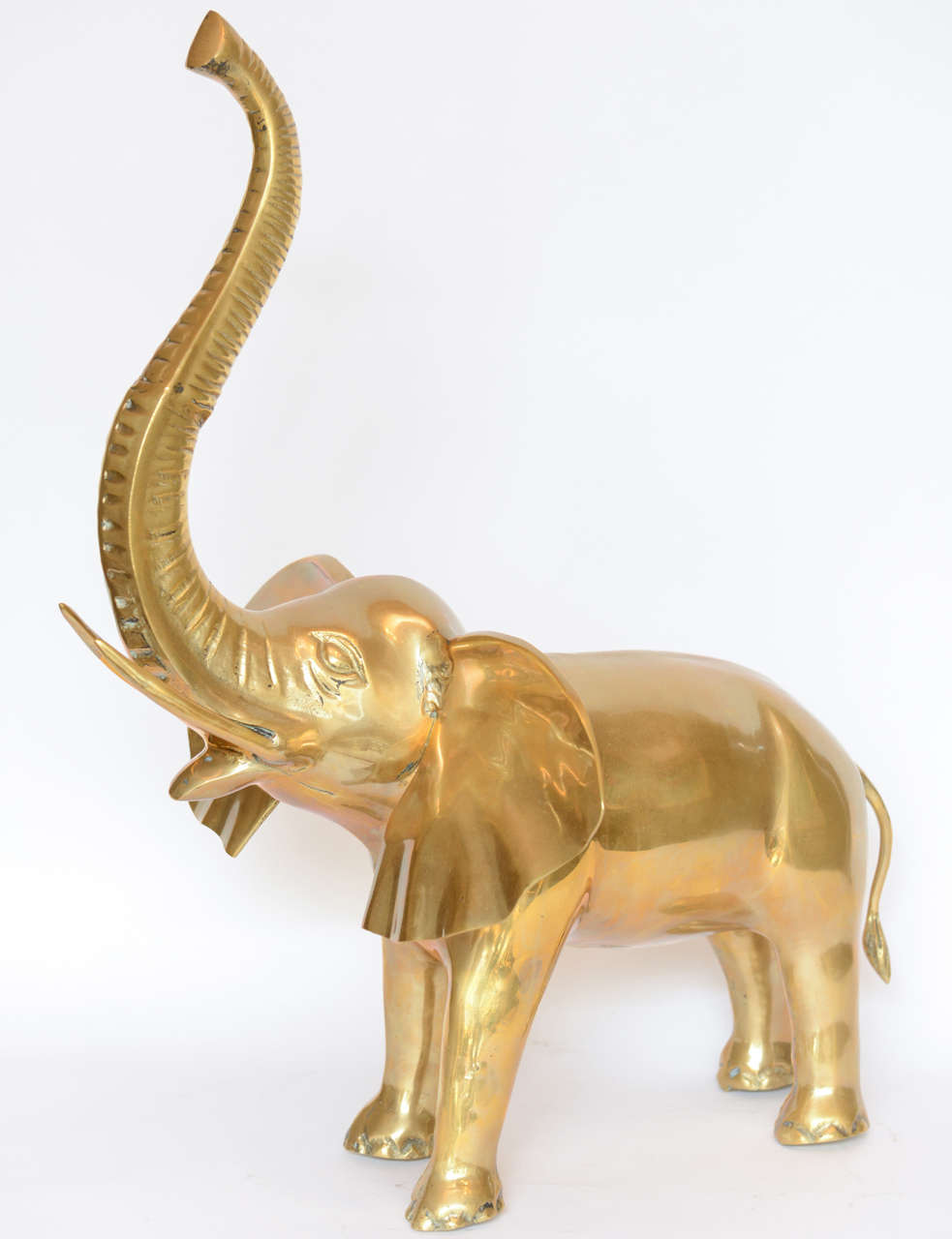 A majestic large scale brass elephant sculpture.