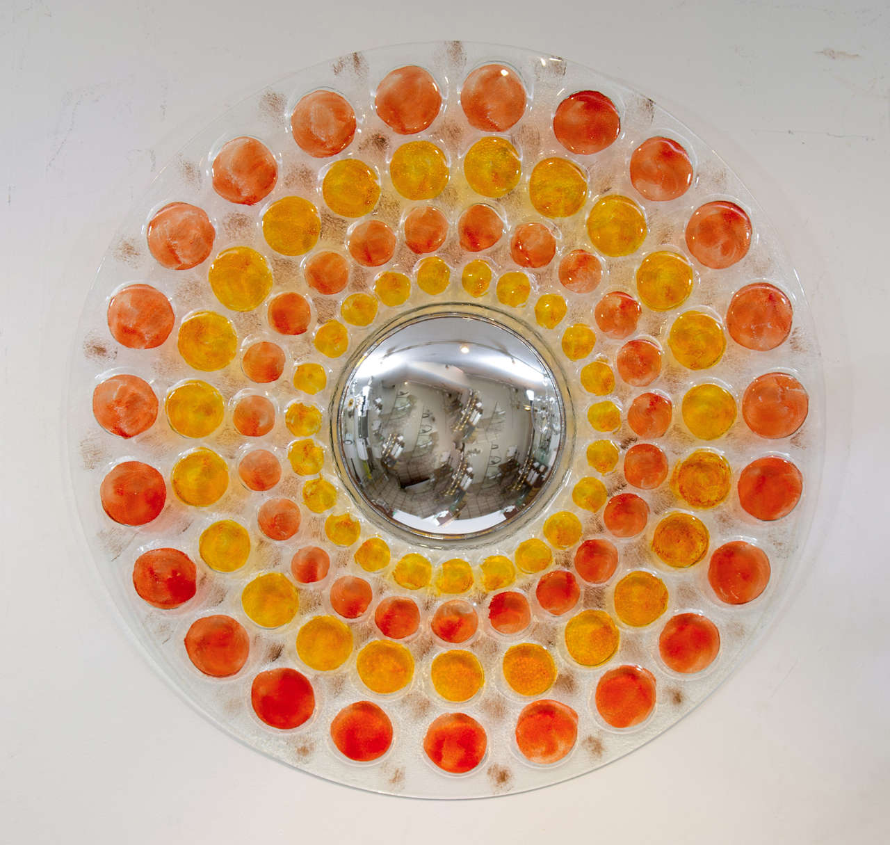 A colourful and fabulous molded glass framed mirror with radiating orange and yellow 