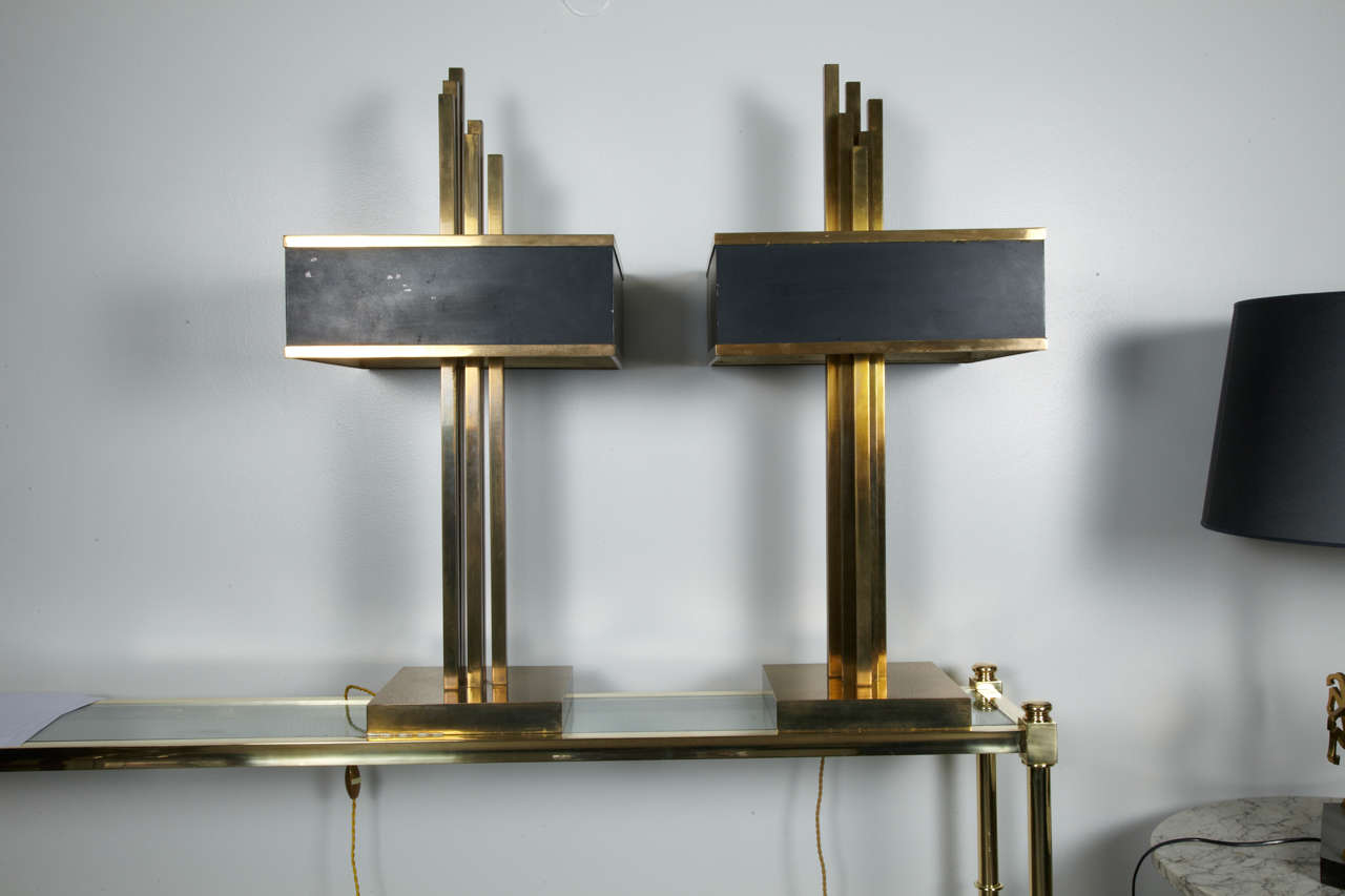 Pair of large lamps in gilded brass and black metal , with new white plexiglass plaques.
By Roger Thibier , circa 1978.
Very decorative and impressive.