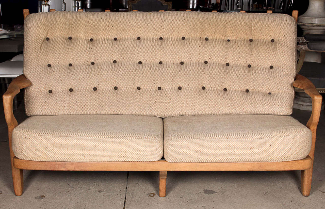 Designed in the 1960's
Iconic settee  with its original beige wool fabric which is vintage but still in good condition