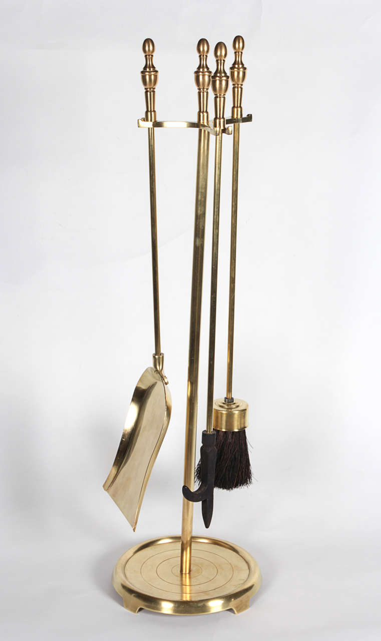 Set of fireplace tools in polished brass.  USA, circa, 1980.  Includes shovel, poker and brush.