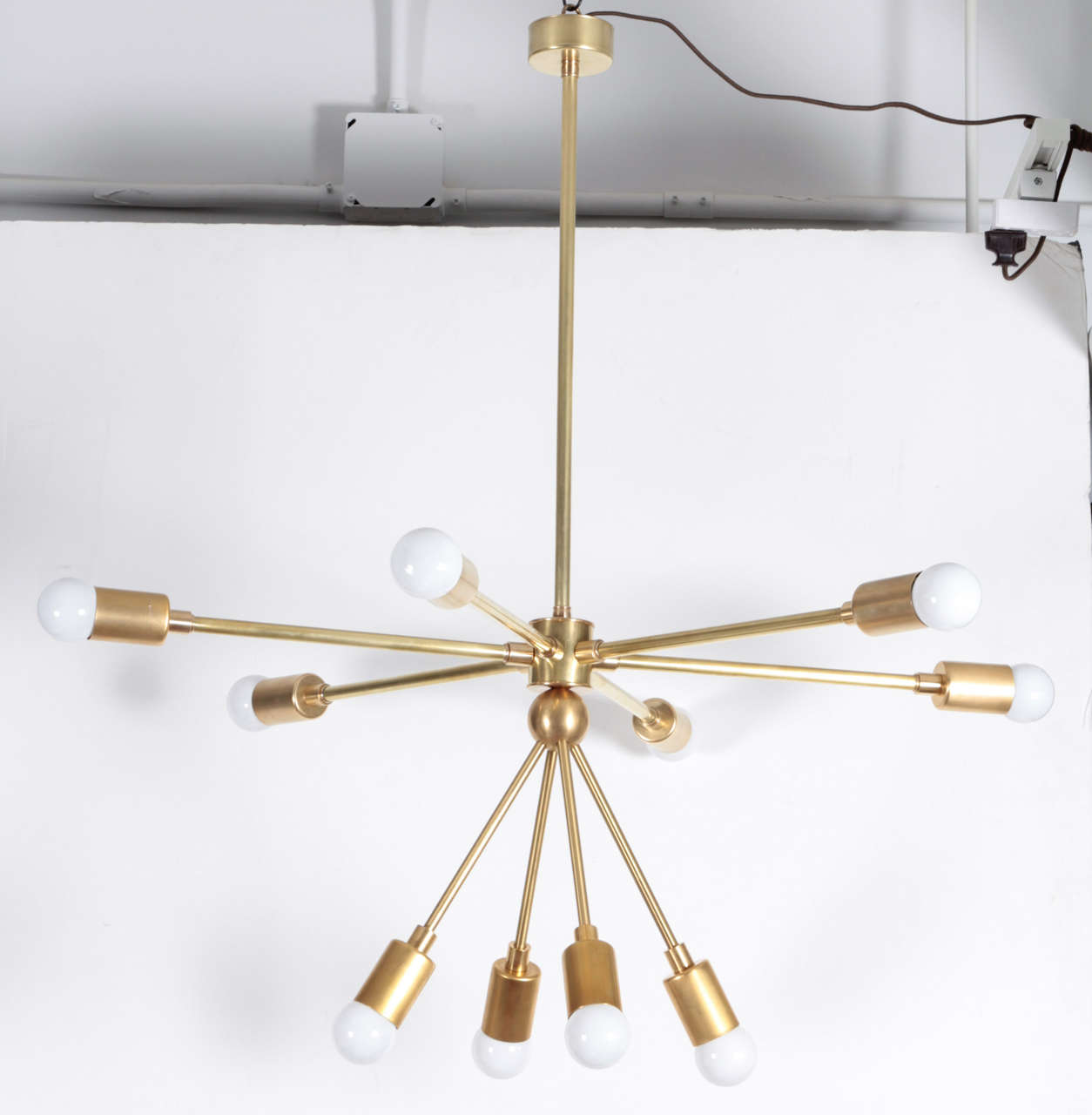 The Macomber Sputnik-style light fixture. USA, new production. Features six horizontal arms and four downward arms. Polished brass. This is a custom item; available ready made in dimensions provided below or as a custom piece with 2 to 4 week