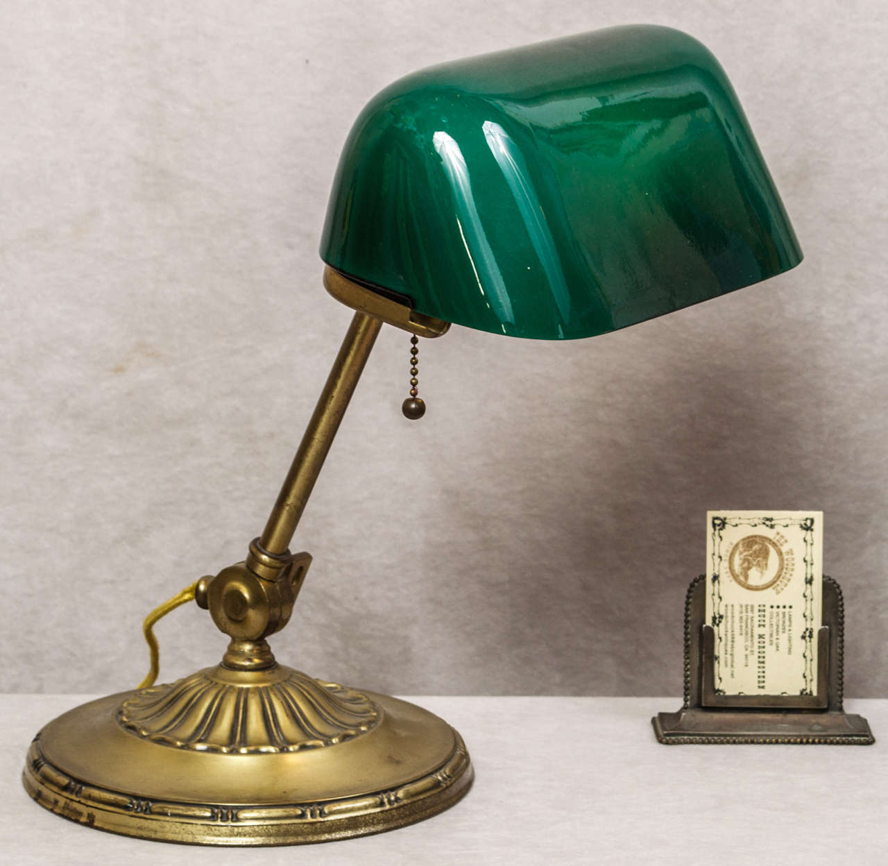 Here is a very fine example of the highly sought after desk lamp for the professional or student.  This particular model was made by the most famous maker of these lamps, Emeralite.  It is signed and does have the original shade, which is also