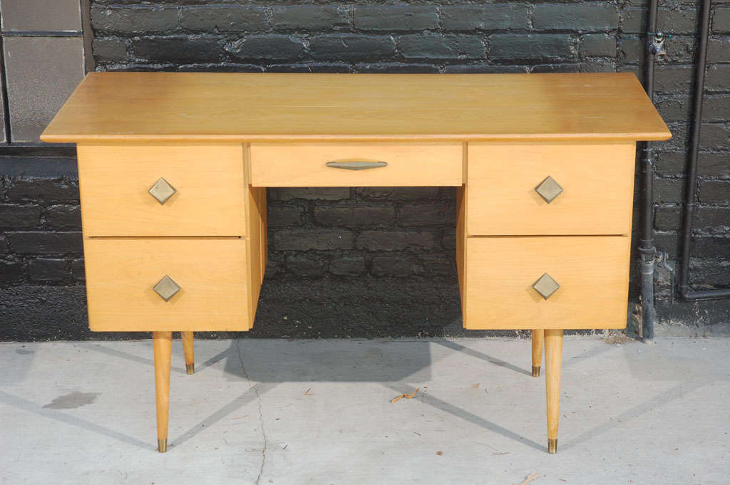 Mid-century blonde wood  5 drawer desk in the manner of Paul McCobb  with metal hardware