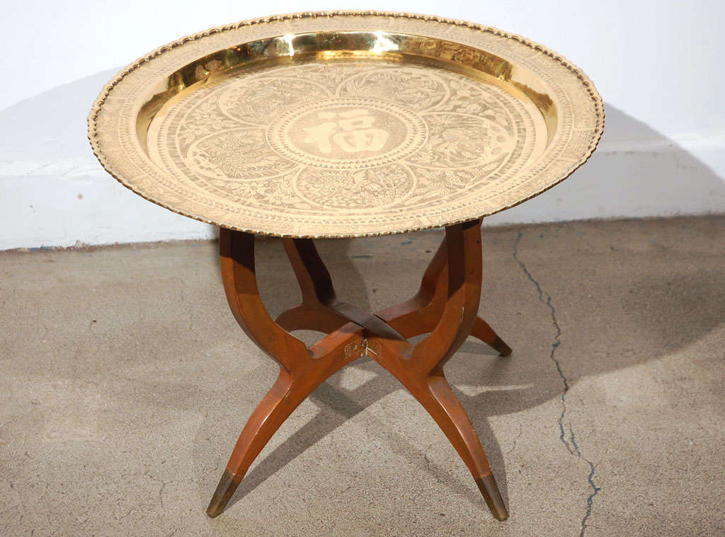 Mid Century modern vintage brass tray table.
Chinese polished brass is hand-chased with chinese scenes and chinese writing in the center.

