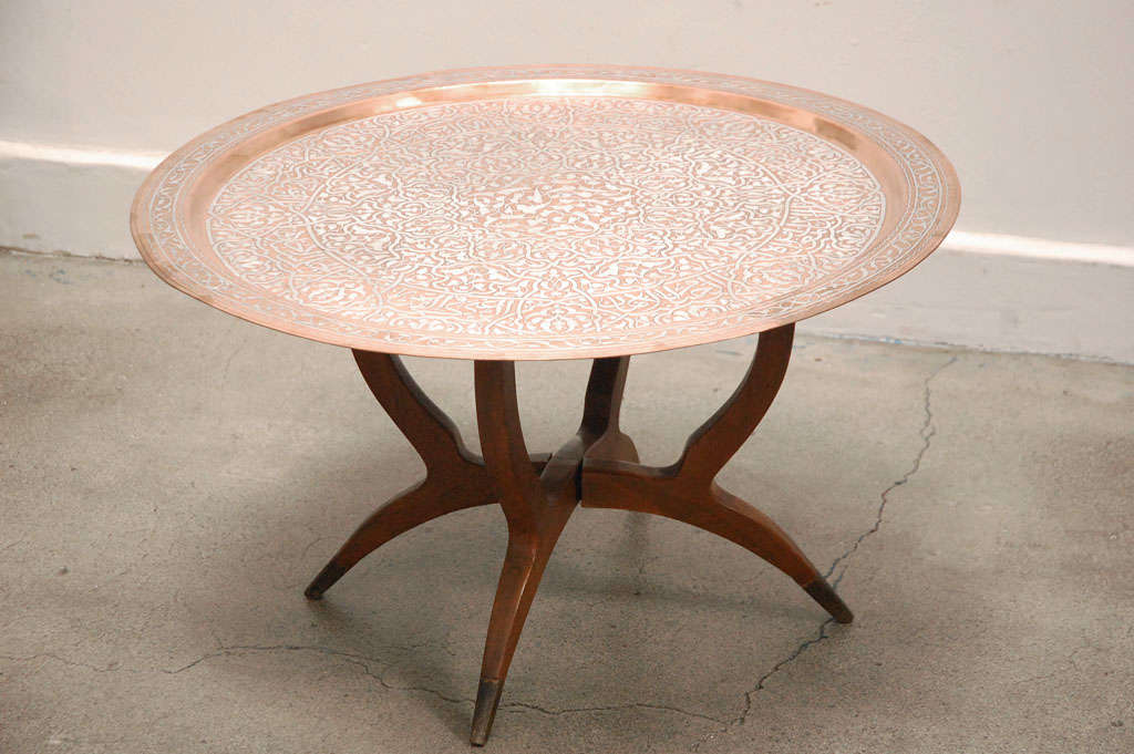Middle Eastern copper tray table, Islamic Egyptian metal artwork. Very decorative large brass tray table, the tray is very beautiful and unusual inlaid with silver Islamic Calligraphy writing and foliates patterns. This kind of Islamic metal Artwork