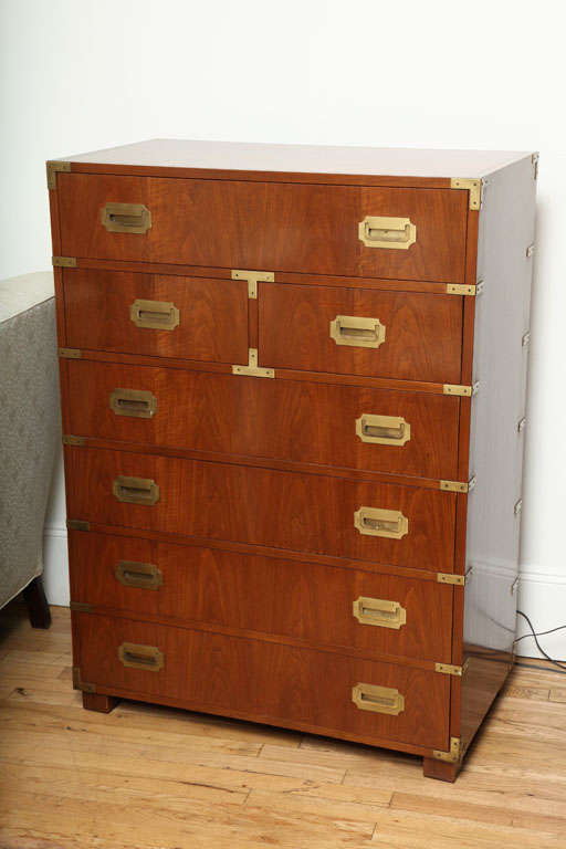 One Campaign style chest of drawers with 7 drawers and brass pulls. Brass details along front and back of chest. Chest was made by Baker and is no longer available.