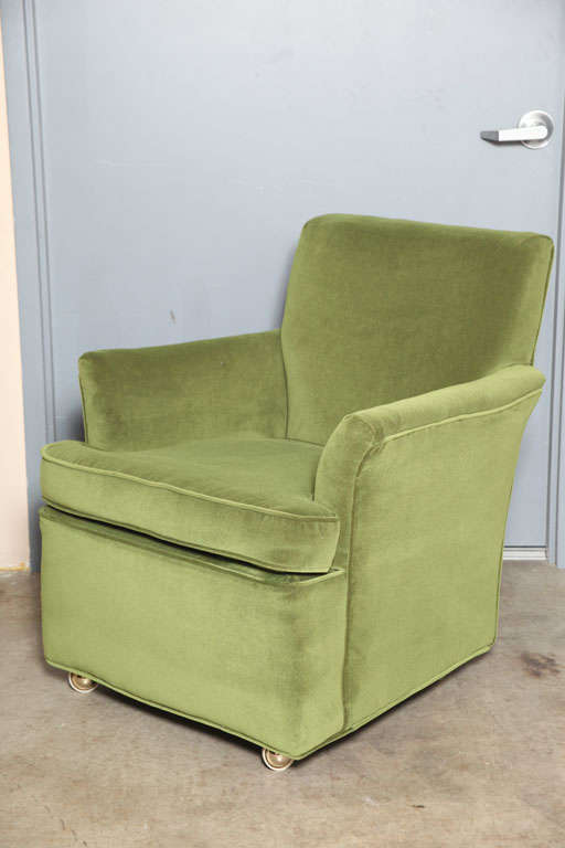 Classic and comfortable armchairs on casters. 
Newly upholstered in a vintage  Velvet.