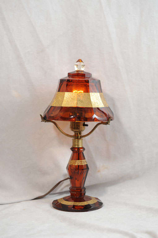We are not known to buy much of this style lamp, but we could not resist this lamp.  It is so charming and clean, it took our breath away.  The beautiful amber glass is highlighted with gold enamel in relief.  Besides the floral and geometric