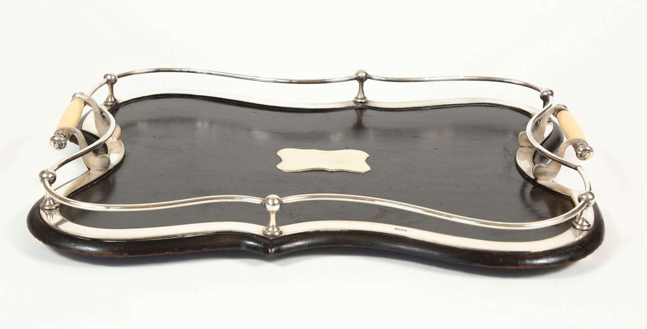 Vintage bar tray with black painted wood and silver plate galley railing, feet and center chest and horn handles.