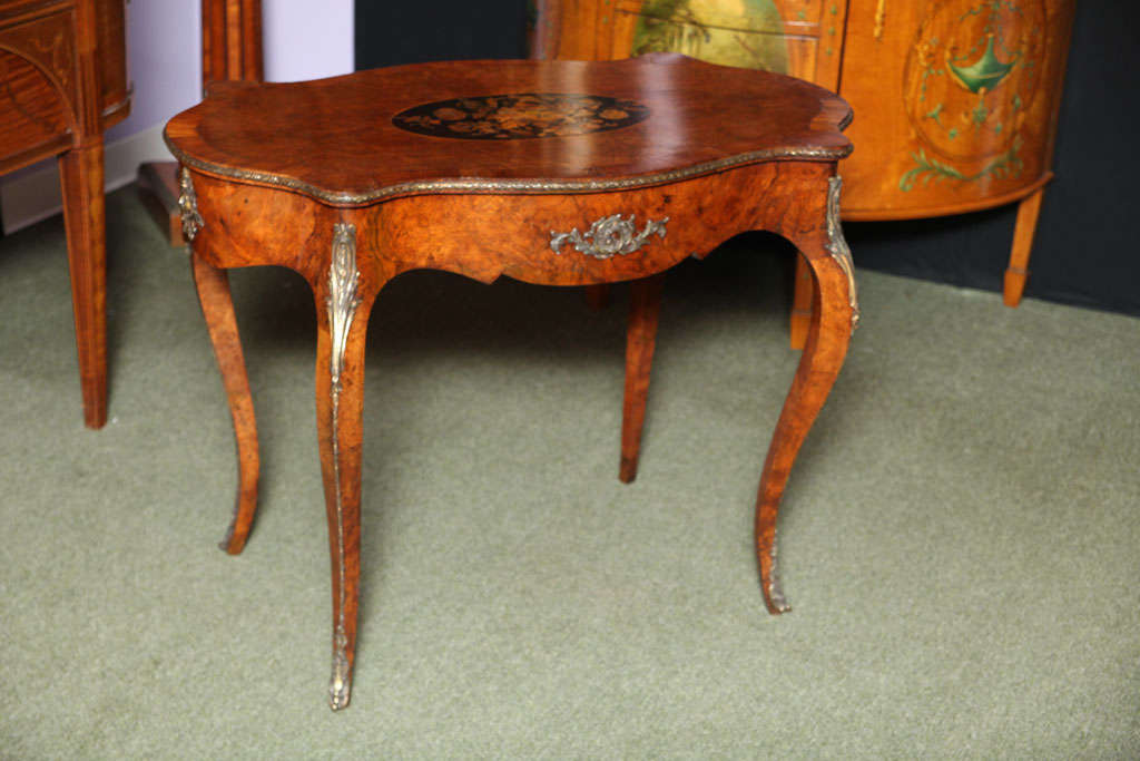 A Fine English antique Burr Walnut Center Table, the central oval section is superbly inlaid with flowers.