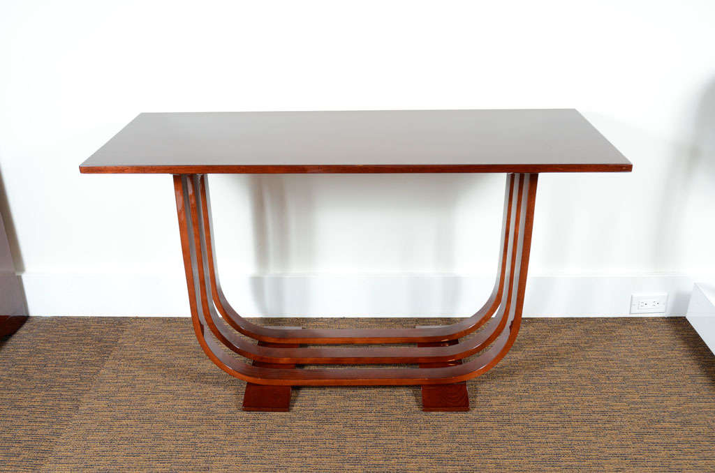Gilbert Rohde console manufactured by Heywood Wakefield. Steam bent maple with U- shaped legs and a mahogany top.