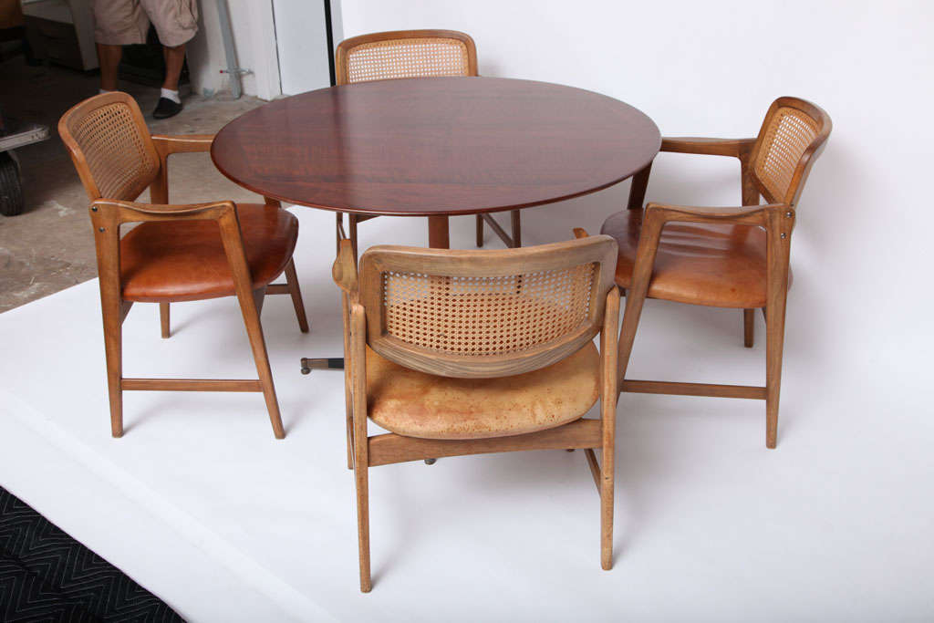 Harvey Probber Table and four chairs,manufactured by Harvey Probber Inc.<br />
Oak,Cane,Leather and Brass.Table top has been refinished.<br />
Table 27 1/2