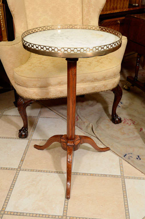 A French Directoire adjustable tilt-top stand with pierced bronze gallery and marble top. Stamped 'Jacob