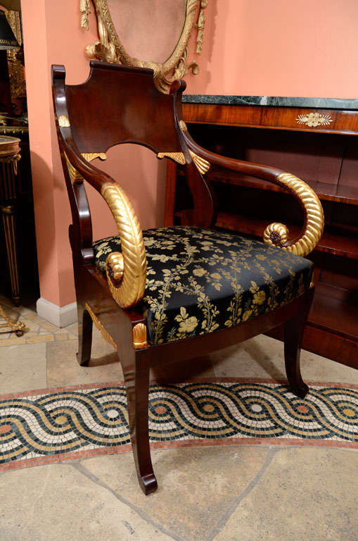A pair of Russian Empire mahogany and gilt carved Fauteuil's.