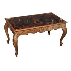 Carved wood coffee table with eglomise top