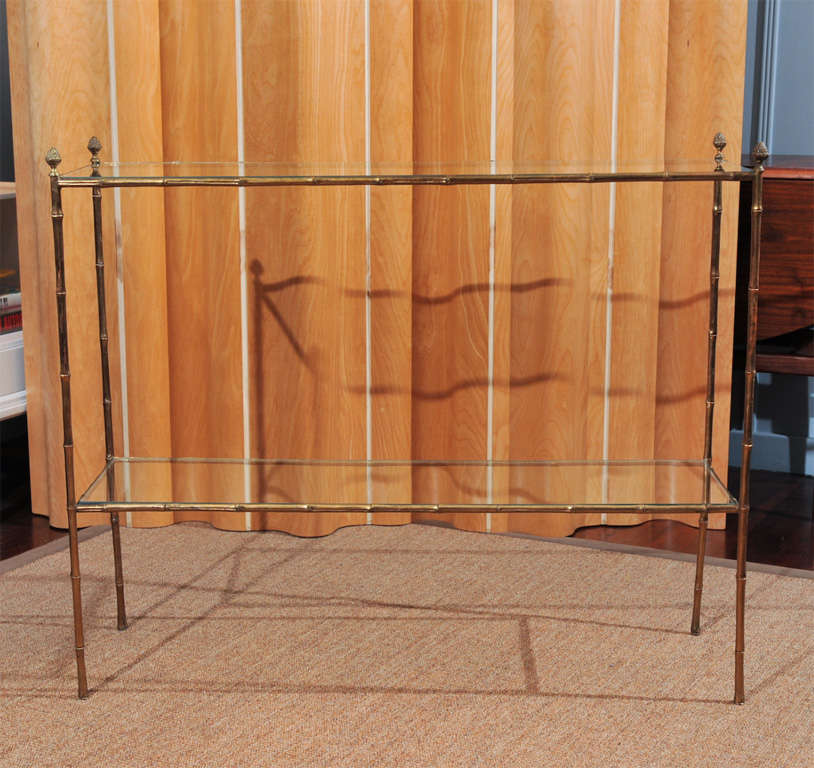 Bagues style brass console table designed and made in Mexico City. High quality castings with new glass shelves. Net $2000.00 Previously $3000.00