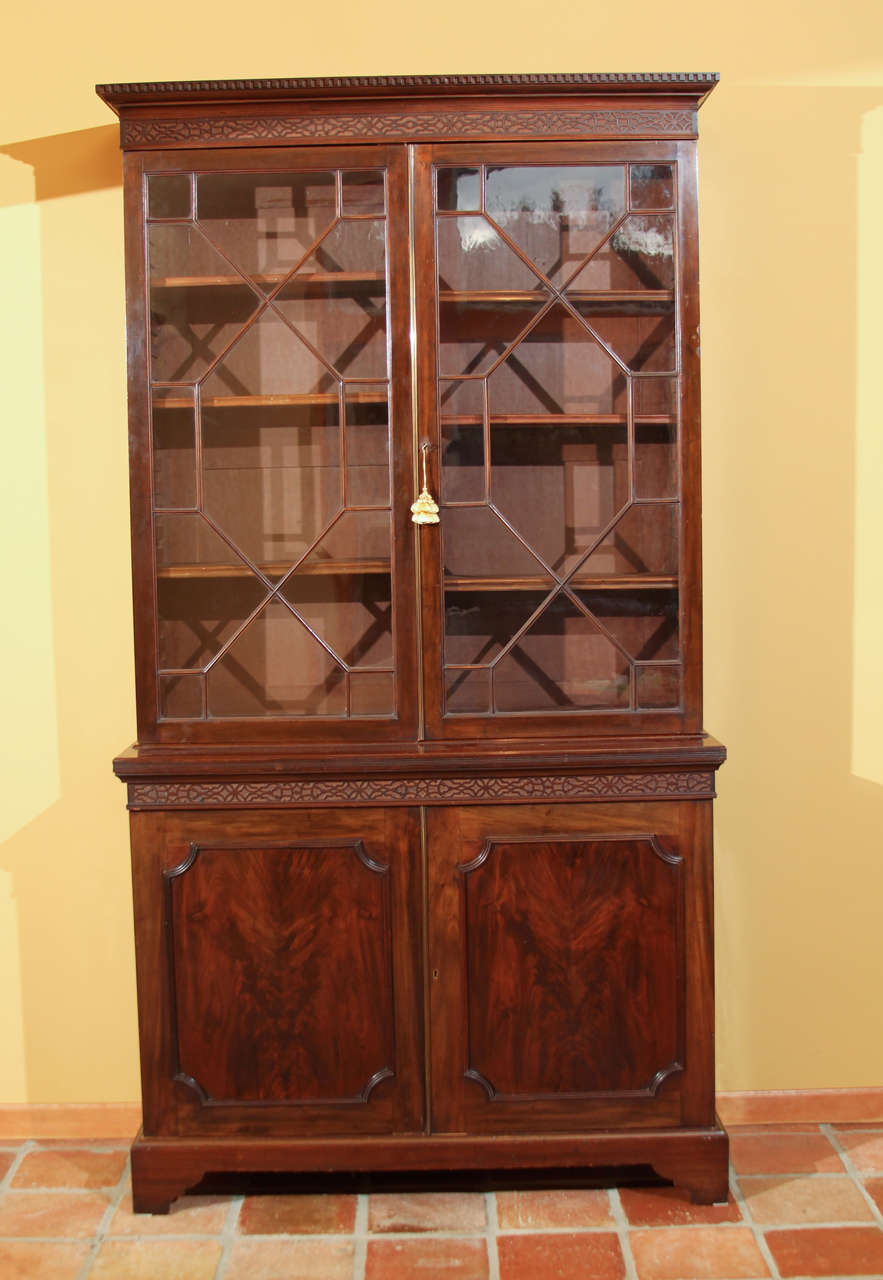 English George III Bookcase with original Glass Doors

This is a wonderful bookcase with Honduran Mahogany wood and the original finish.

The top has blind fret-work under the crown molding. It has thirteen panes of glass per door (which is