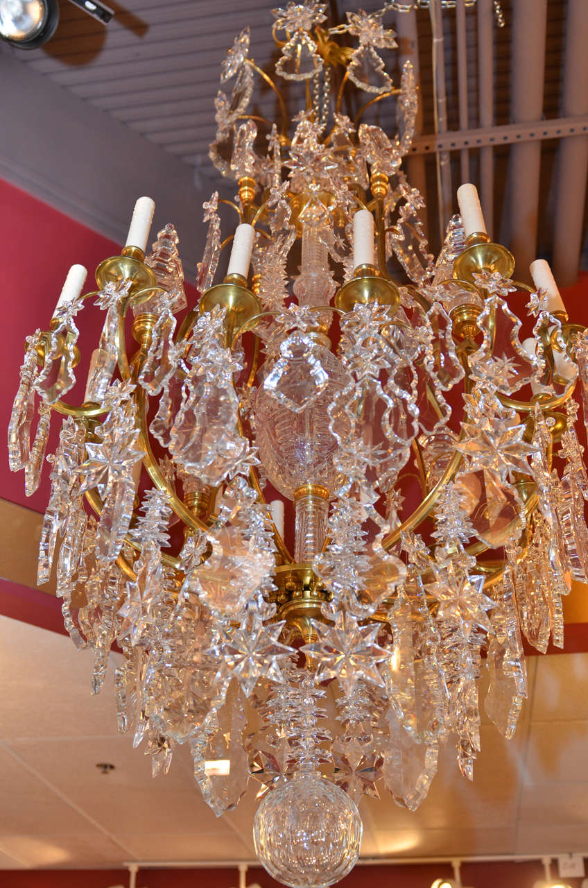 A very fine Louis XV gilt bronze 'cage' style chandelier having sixteen lights with magnificent crystal pendalogues.