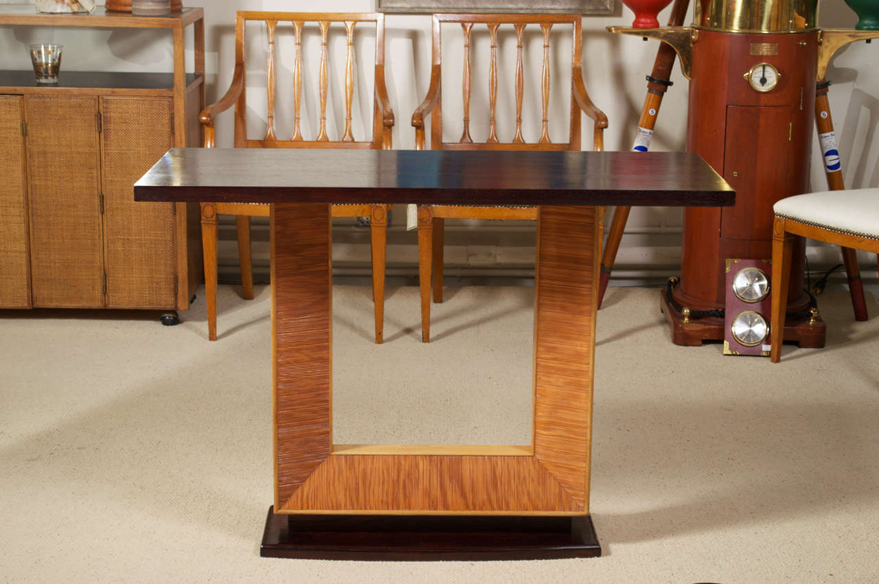 A circa 1940's console table, designed by Paul Frankl for Brown Saltman, Top is Mahogany, with White Oak and Oak. Three panels on each side are textured. Top and base are in a dark reddish brown.
