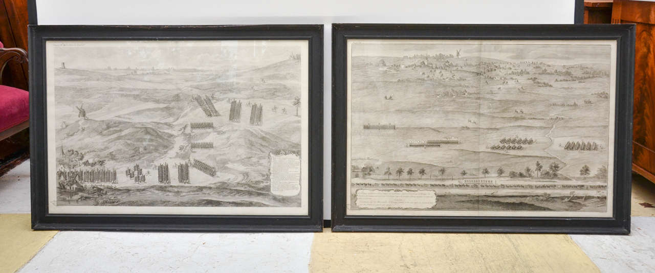 Pair of large 18th century, French military Campaign etchings. They each have a floral bordered cartouche (in French) each describing military Formations of soldiers in a hilly rural landscape with windmills, a church and domestic Dwellings. Marked