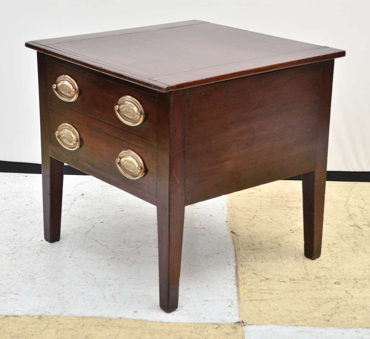 English early 19th century Georgian square low table with two ebony banded false drawers. The false drawers have original brass pulls impressed with sheaves of wheat sprouting out of rocks. This is an unusual form of a potty, (see image 5) or