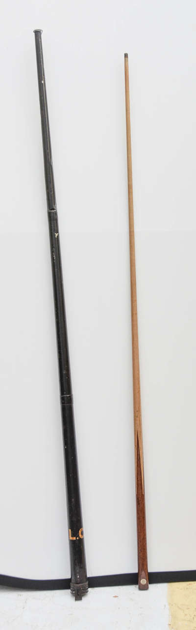 English Victorian tole pool cue case (with white painted initials L.C.) having hinged cap. Included is late 19th-early 20th century oak and maple pool cue with ivorine circular label 