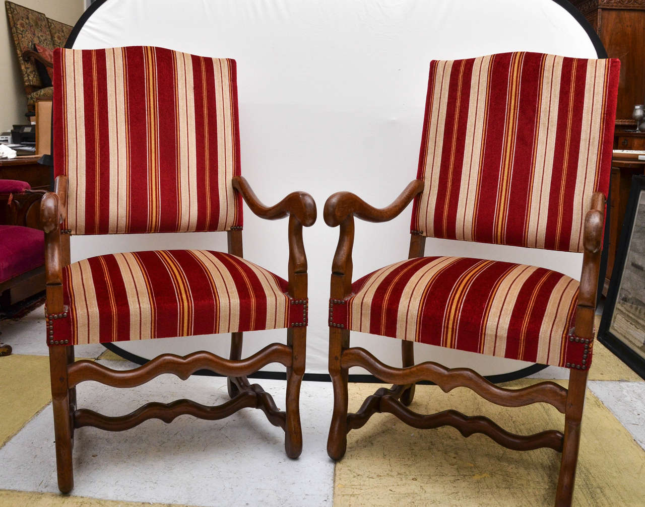 French early 20th century Oz De Mouton style open-arm salon chairs. Upholstered in a handsome red, khaki and yellow stripe velvet with almost no wear. The arms and legs are polished oak. The chairs are very comfortable.