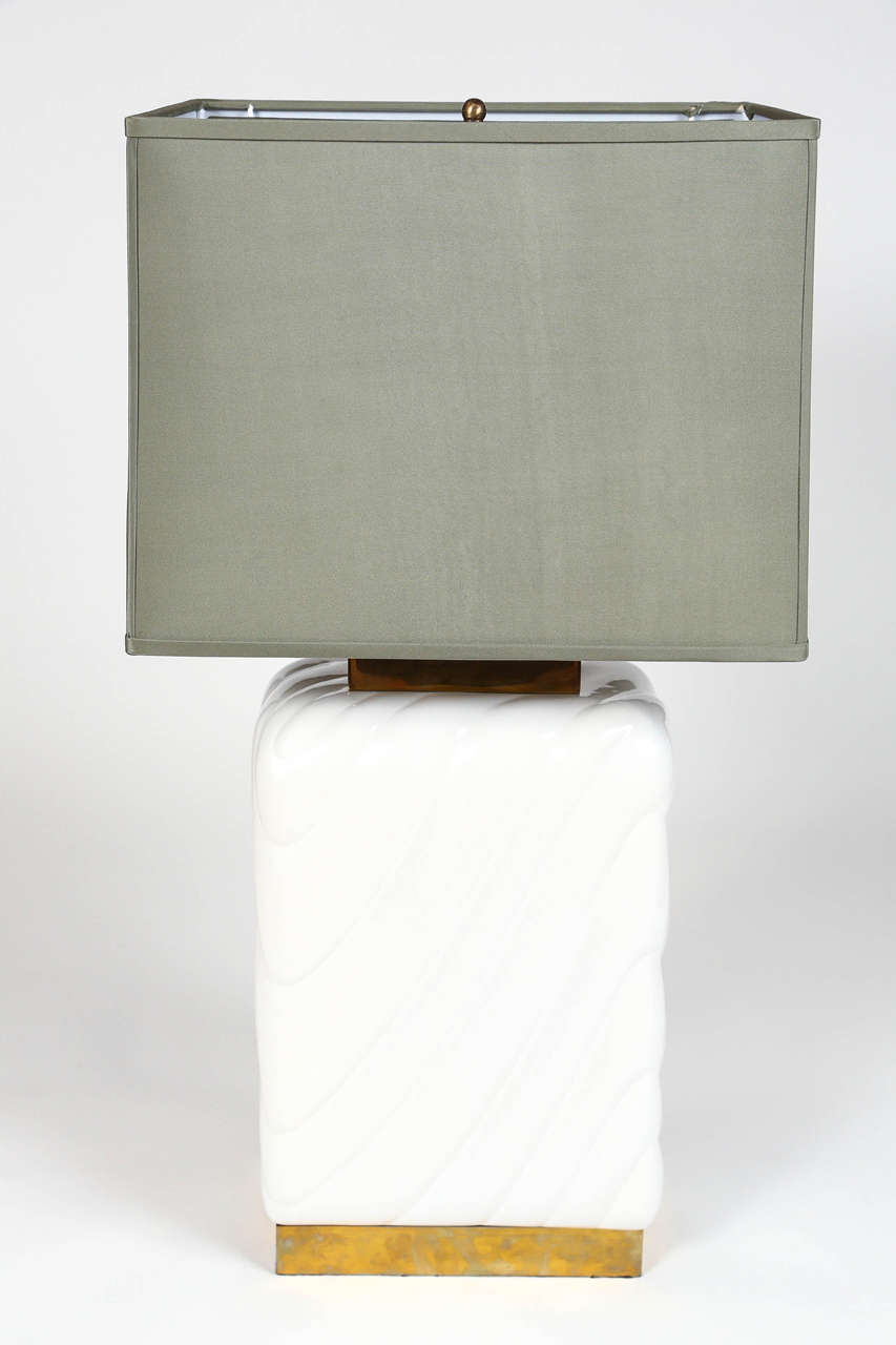 Incredible pair of 1970's high gloss white ceramic table lamps.  Rectangular marshmallow shape with brass hardware.  Rectangular lampshades included in celedon shantung silk.

Shade: 11