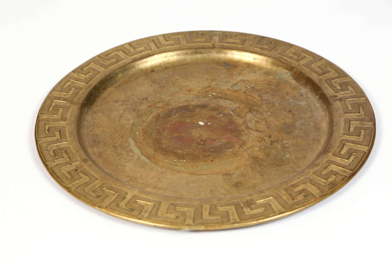 Vintage brass charger with Greek key detail.