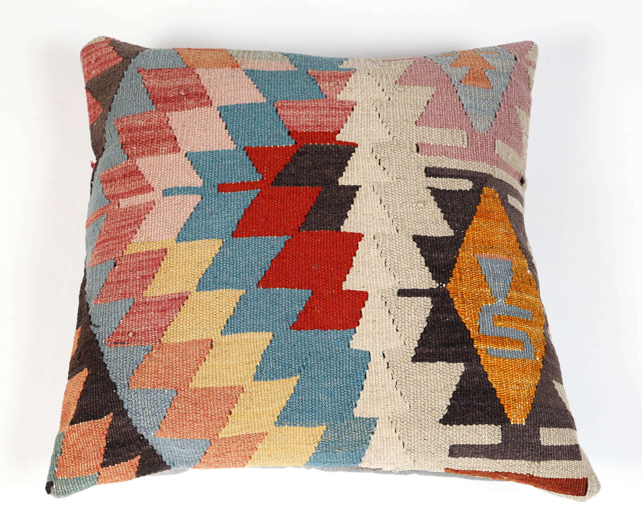 Vintage kilim pillow decorated with a geometric pattern. Solid pale blue fabric backing.