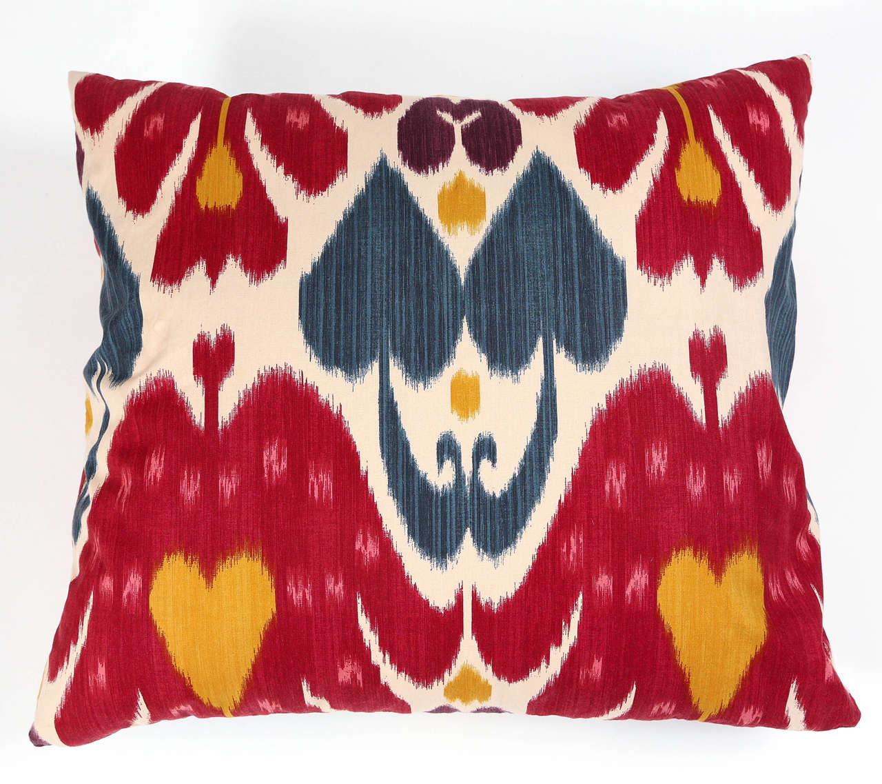 Throw pillow in brightly colored Ikat fabric with decorative trim. Insert included. Two available.