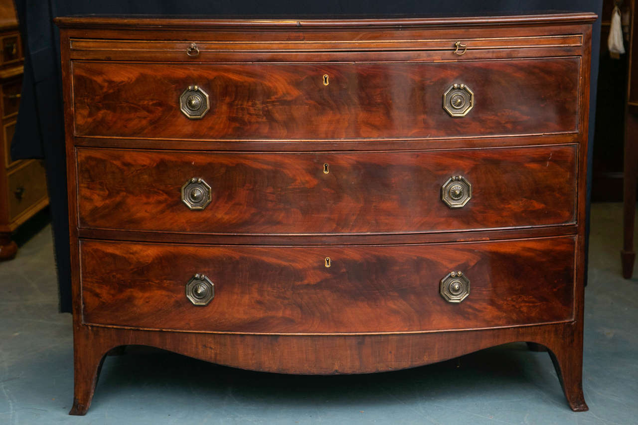 The exceptional grain on this three-drawer chest with slide is rivaled only by the octagonal drawer pulls that have achieved a soft, patina over the years. It would be a shame if someone were to polish them. 
