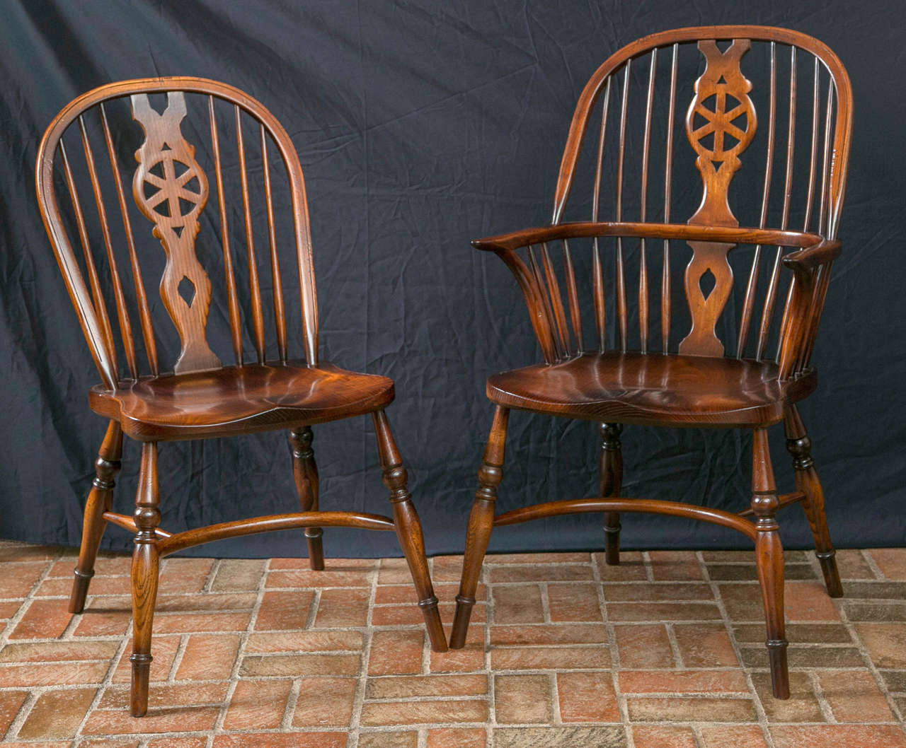 Created using the trusted techniques passed down through the centuries, these wheel back Windsor chairs in oak and ashwood are surprisingly comfortable for chairs constructed of so many parts. The side chair has 16 individual pieces and the armchair