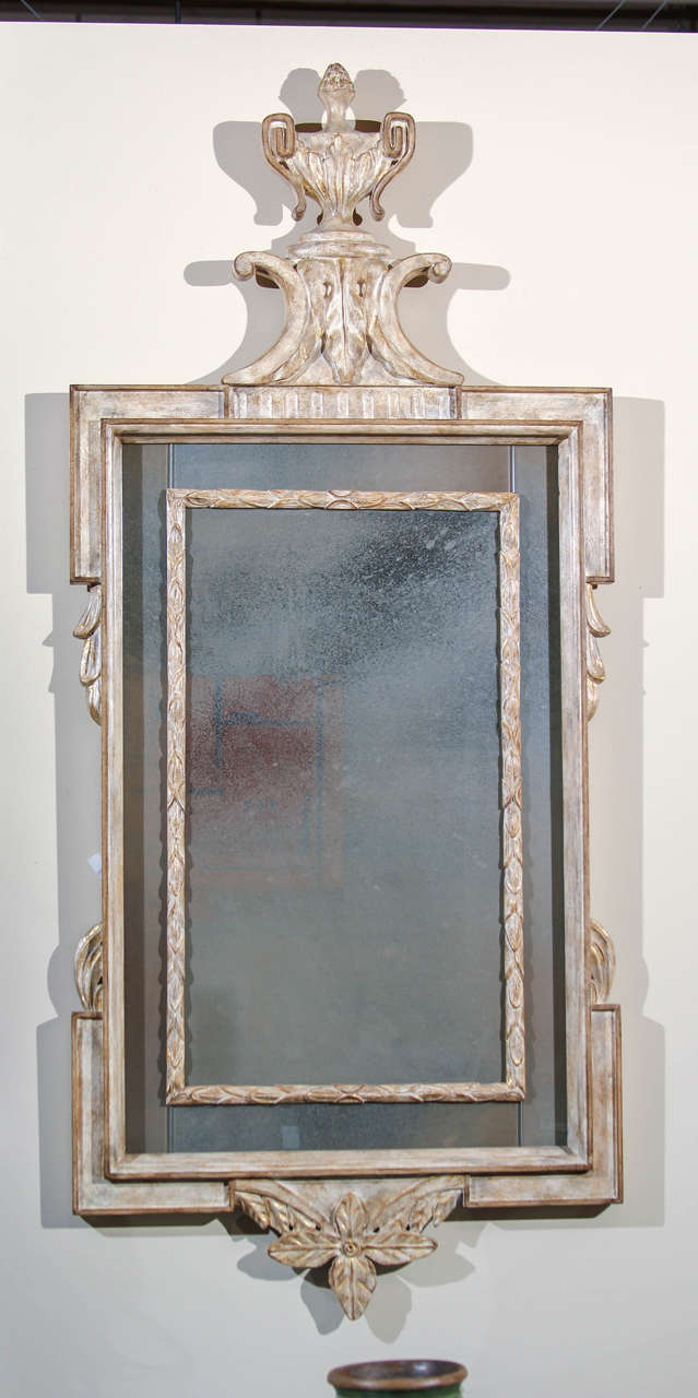 A large and impressive vintage Hollywood Regency style mirror. Carved and pickled wood with vestiges of gilding. The glass is a good very atmospheric and distressed.