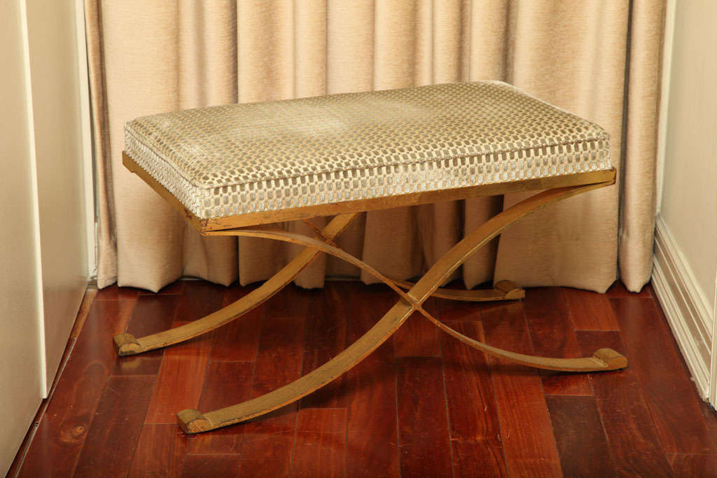 An elegant and classical  Gilt Iron and Velvet upholstery X shape small bench or ottoman, in the Manner of Raymond Subes.