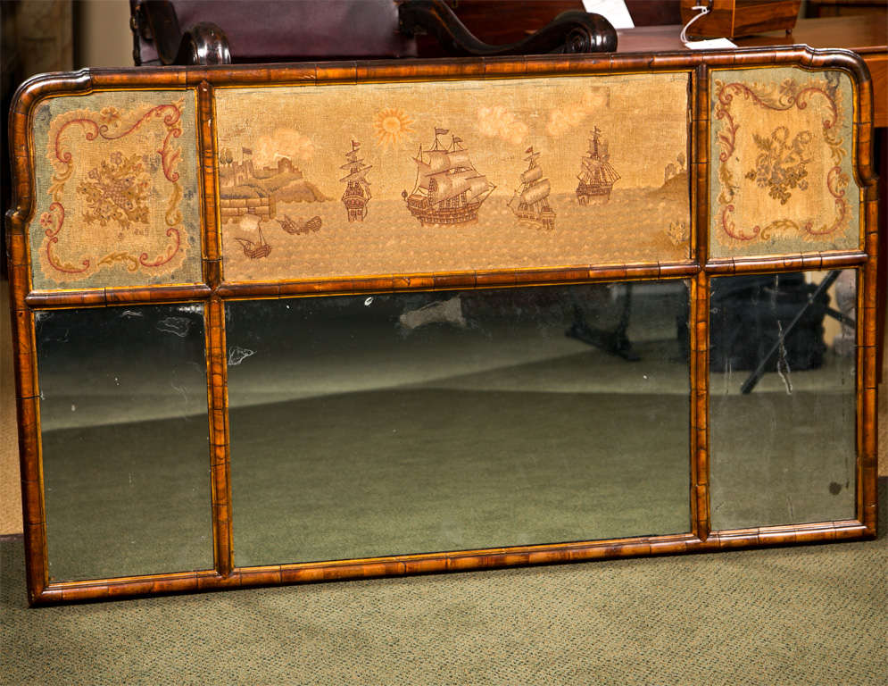 An 18th century,walnut, Queen Anne style over mantle mirror with giltwood and petit point panels.