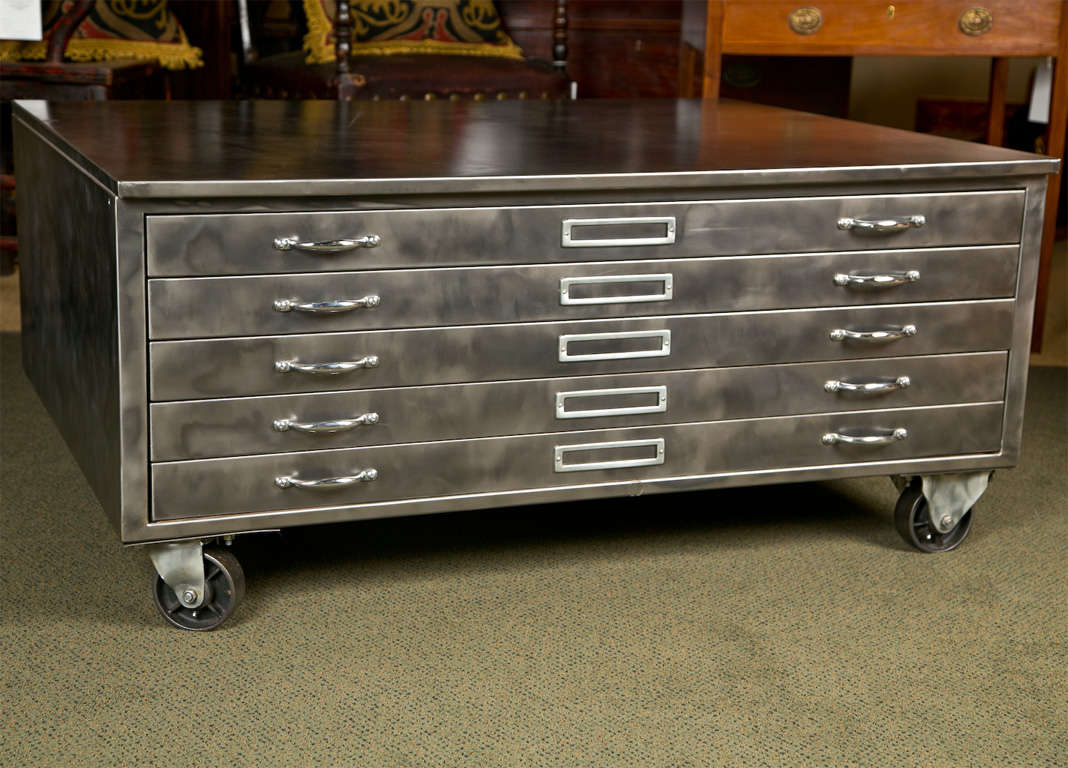 An industrial flat file cabinet on wheels that can be used as a coffee table.