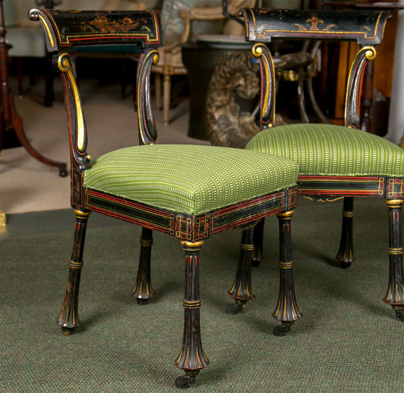 A pair of small Egyptian Revival side chairs.  May be sold separately.